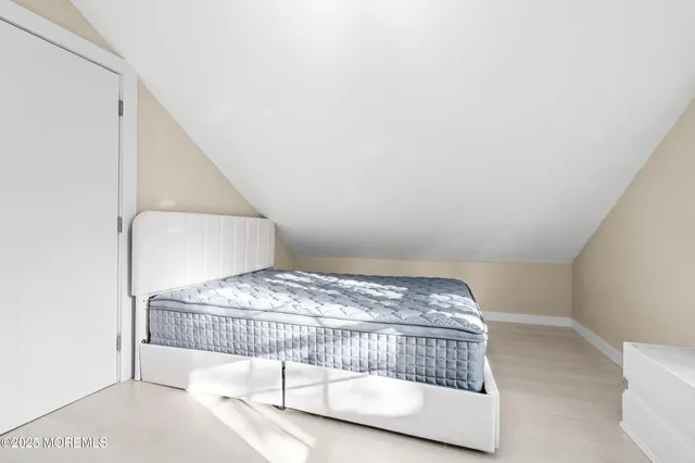 a bedroom with a bed and chair