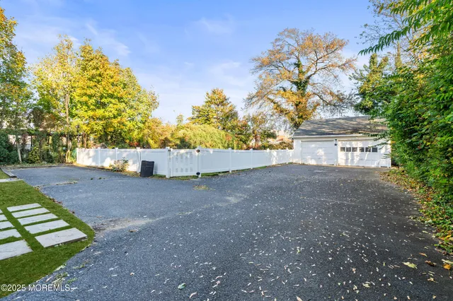 a view of a house with backyard and a tree