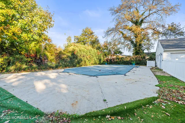 a view of a tennis ground with large trees