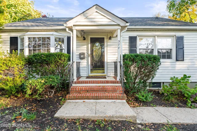 front view of a house with potted plants