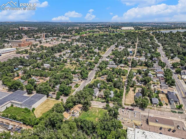 an aerial view of a house with a yard