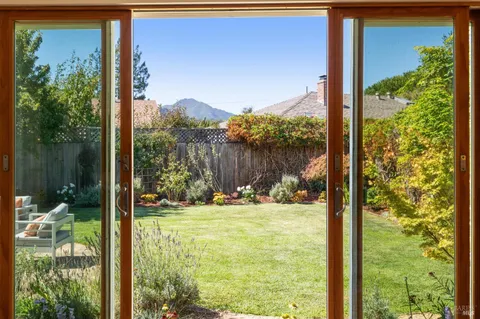 a view of a dry yard with mountains in the background