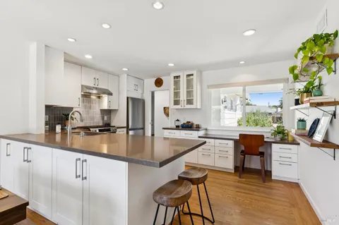 a kitchen with a sink stove and cabinets