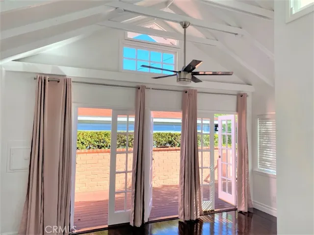 a view of a livingroom with wooden floor and windows