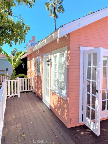 a view of a porch with wooden floor and fence
