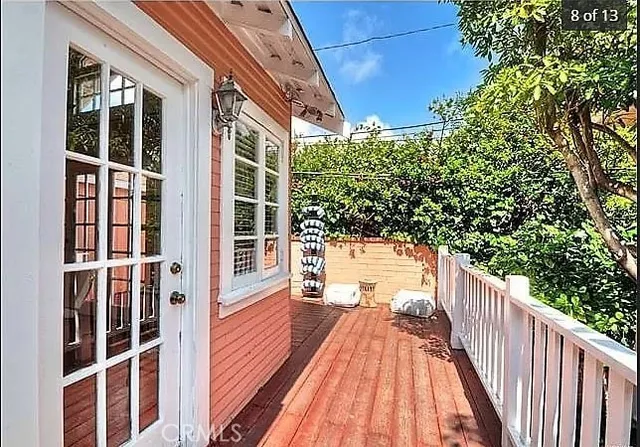 a view of balcony with wooden floor and fence