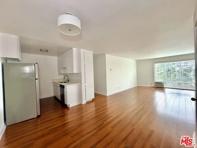a kitchen with a refrigerator and a sink