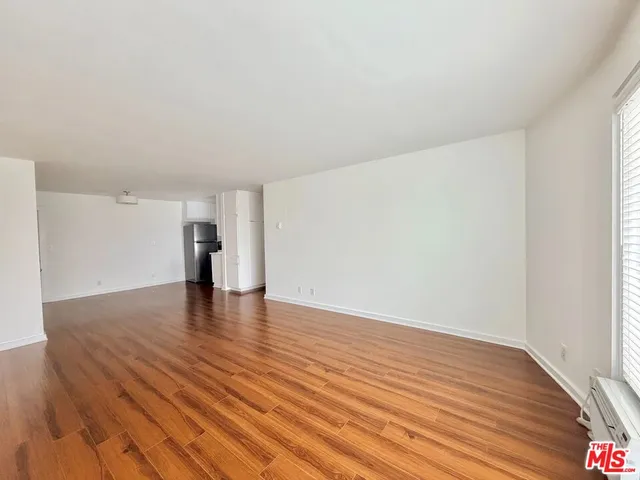 a view of walk in closet with wooden floor