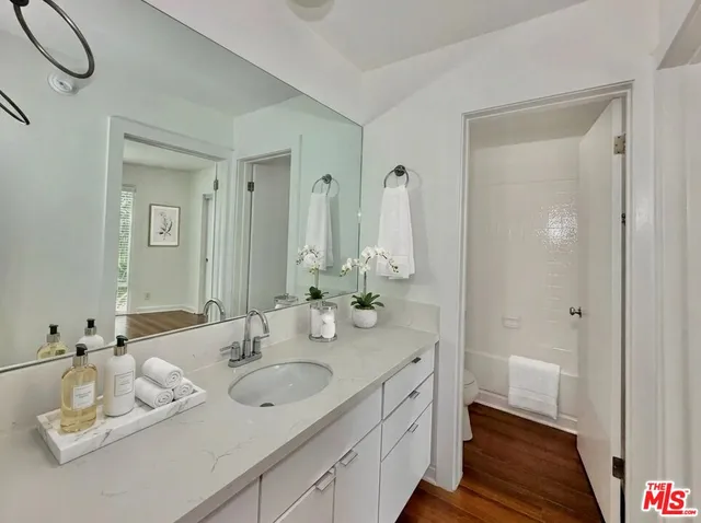 a bathroom with a double vanity sink and a mirror