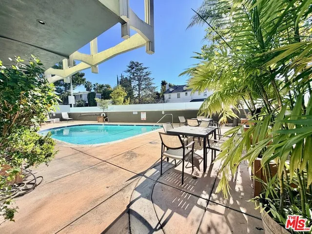 a view of swimming pool with outdoor seating and flowers