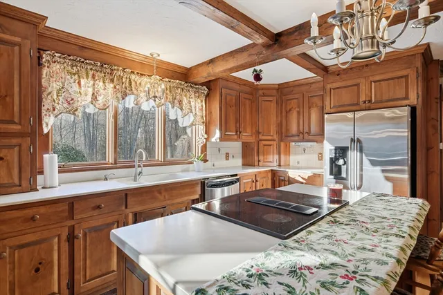 a kitchen with a stove a sink and a refrigerator