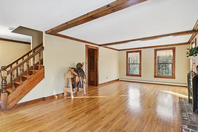 a view of a room with wooden floor and stairs