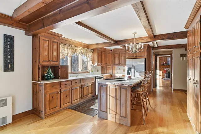 a kitchen with stainless steel appliances granite countertop a stove and cabinets