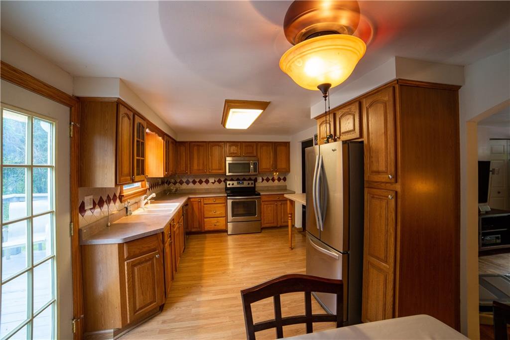 3029 Universal Road Pittsburgh, PA 15235 - Photo 8 of 17 Large eat-in Kitchen equipped with SS appliances, lots of oak cabinetry and counter space.