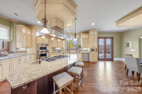 a large kitchen with a table and chairs