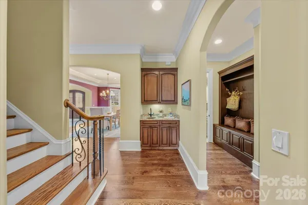 a view of a hallway with wooden floor and entryway