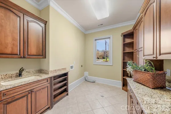 a spacious bathroom with a granite countertop sink and a window