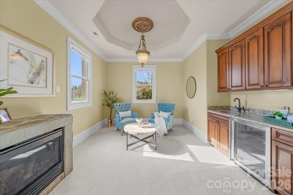 a living room with furniture a fireplace and a window