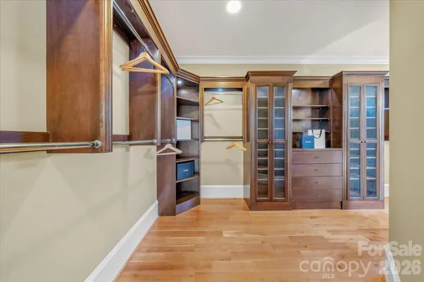 a view of walk in closet with empty racks