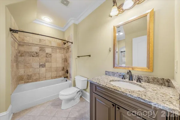 a bathroom with a granite countertop sink toilet a shower and a mirror