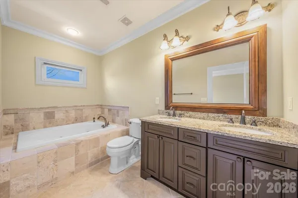 a bathroom with a double vanity sink and a bathtub