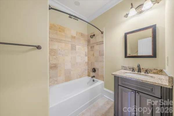 a bathroom with a tub sink and mirror
