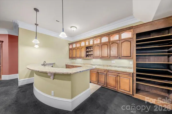a kitchen with kitchen island a sink and a stove