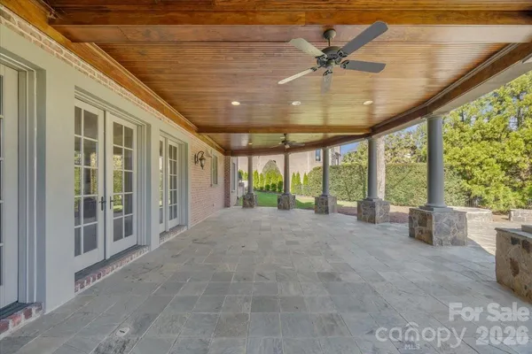 a view of a livingroom with furniture and floor to ceiling window