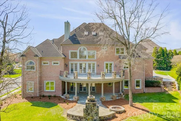 a front view of a building with a garden and plants