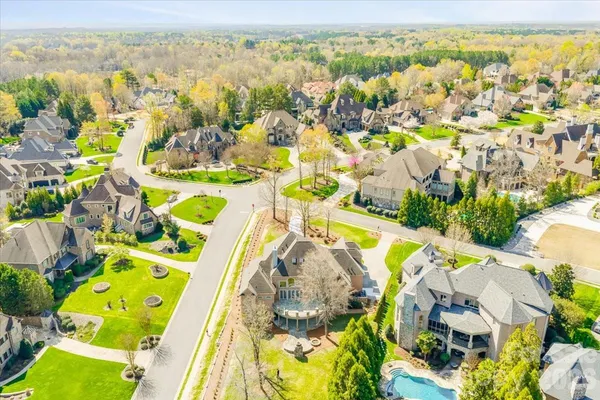 an aerial view of a swimming pool with a yard