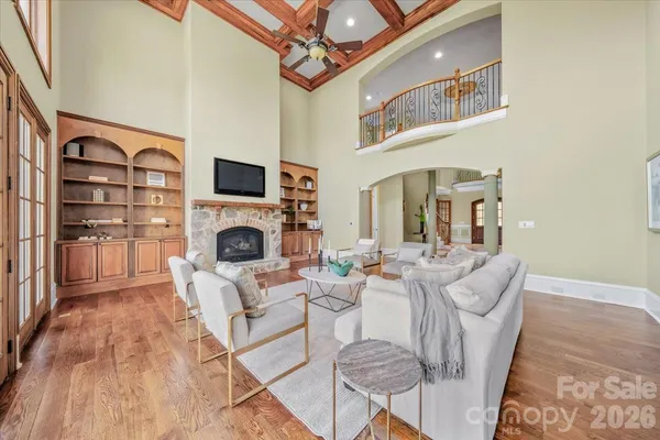 a living room with furniture a fireplace and a flat screen tv