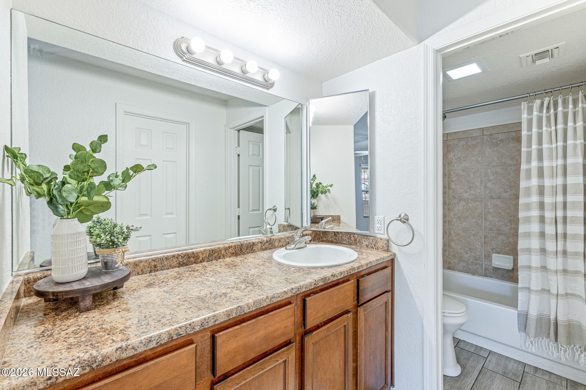 5800 North Kolb Road, Unit 1104 Tucson, AZ 85750 - Photo 11 of 29 Large primary bathroom has lots of counter space an a huge walk-in closet behind through the door.