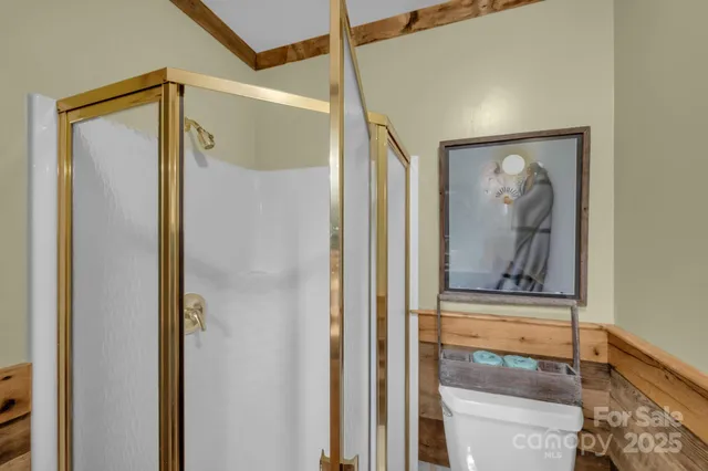 a bathroom with a glass shower door and a shower