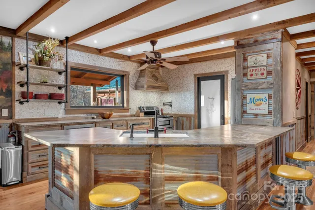 a kitchen with a table chairs and a chandelier