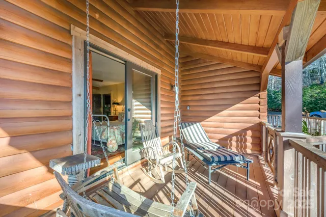 a living room with furniture a flat screen tv and kitchen view
