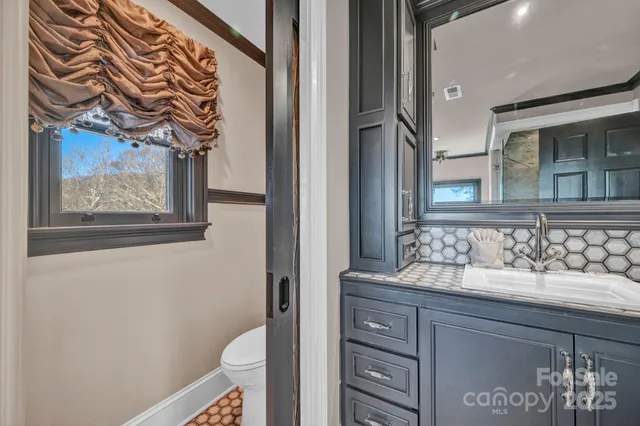 a bathroom with a tub and a view of bathroom