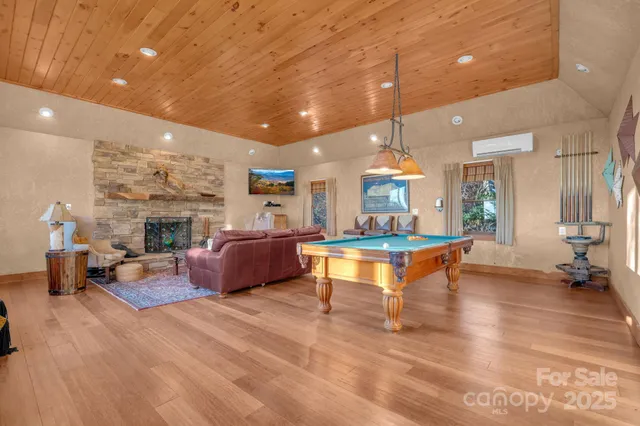 a living room with furniture a fireplace and a chandelier