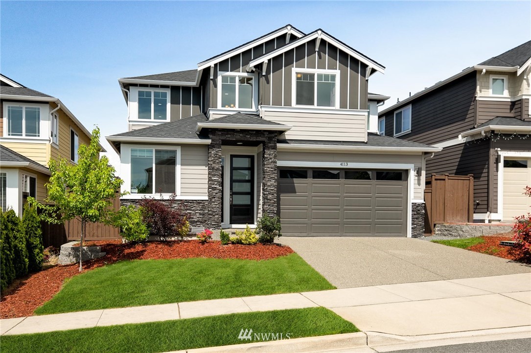 4113 172nd Place Southeast Bothell, WA 98012 - Photo 1 of 32 a front view of a house with a yard and garage