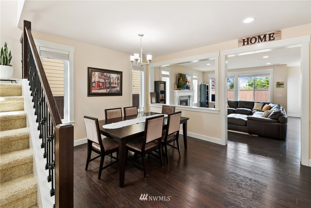 4113 172nd Place Southeast Bothell, WA 98012 - Photo 14 of 32 a view of a dining room with furniture window and wooden floor