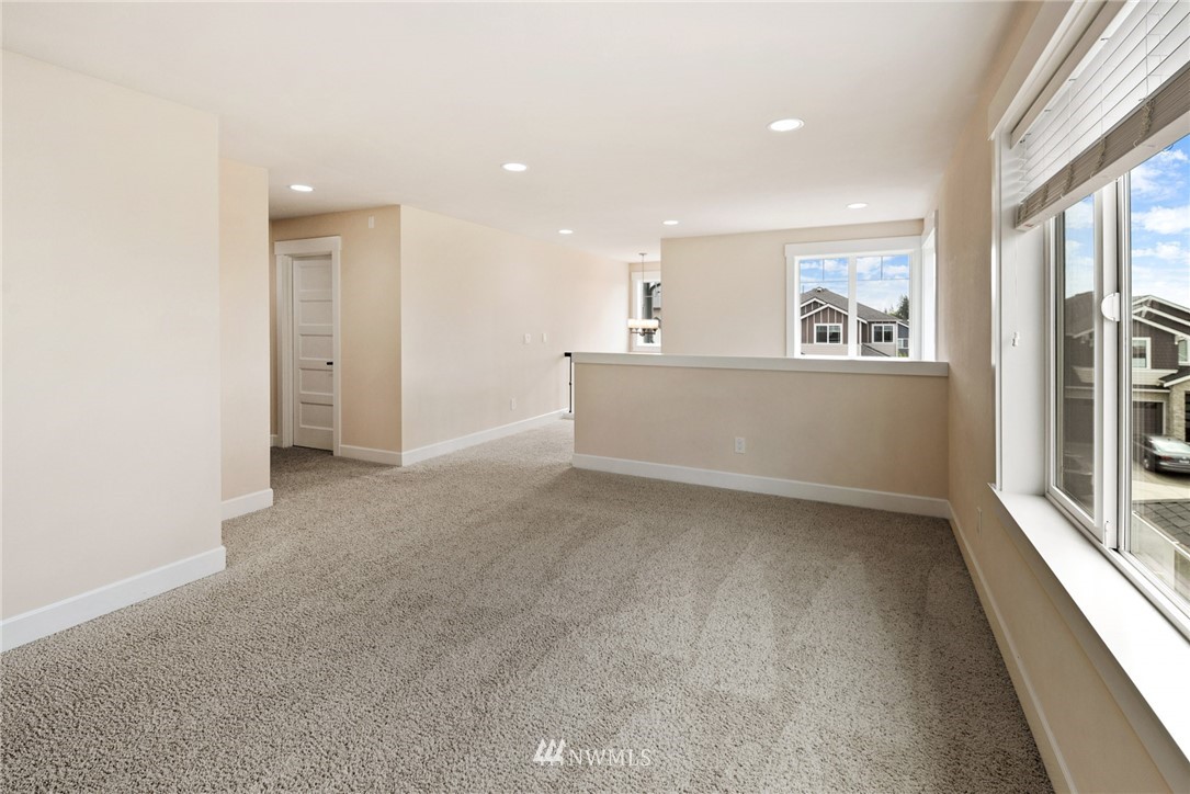 4113 172nd Place Southeast Bothell, WA 98012 - Photo 17 of 32 a view of a big room with windows and chandelier