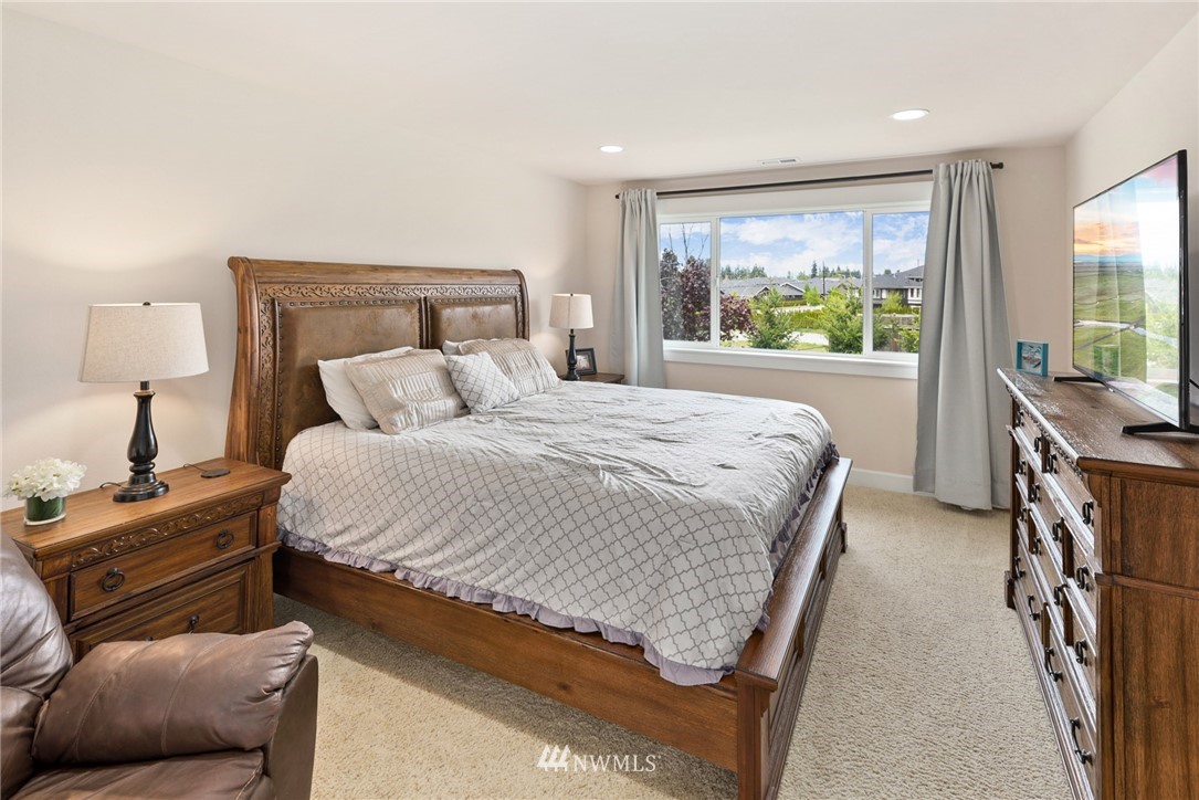 4113 172nd Place Southeast Bothell, WA 98012 - Photo 19 of 32 a bedroom with a bed and a night stand