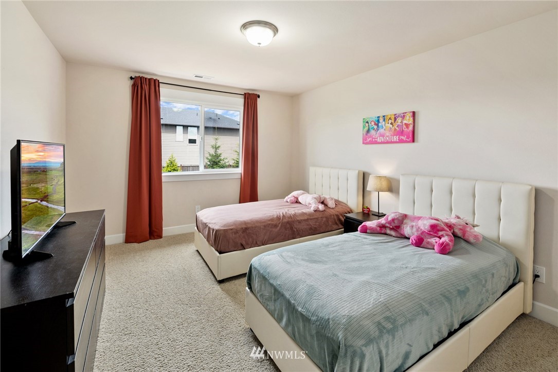 4113 172nd Place Southeast Bothell, WA 98012 - Photo 24 of 32 a bedroom with two bed and a flat screen tv