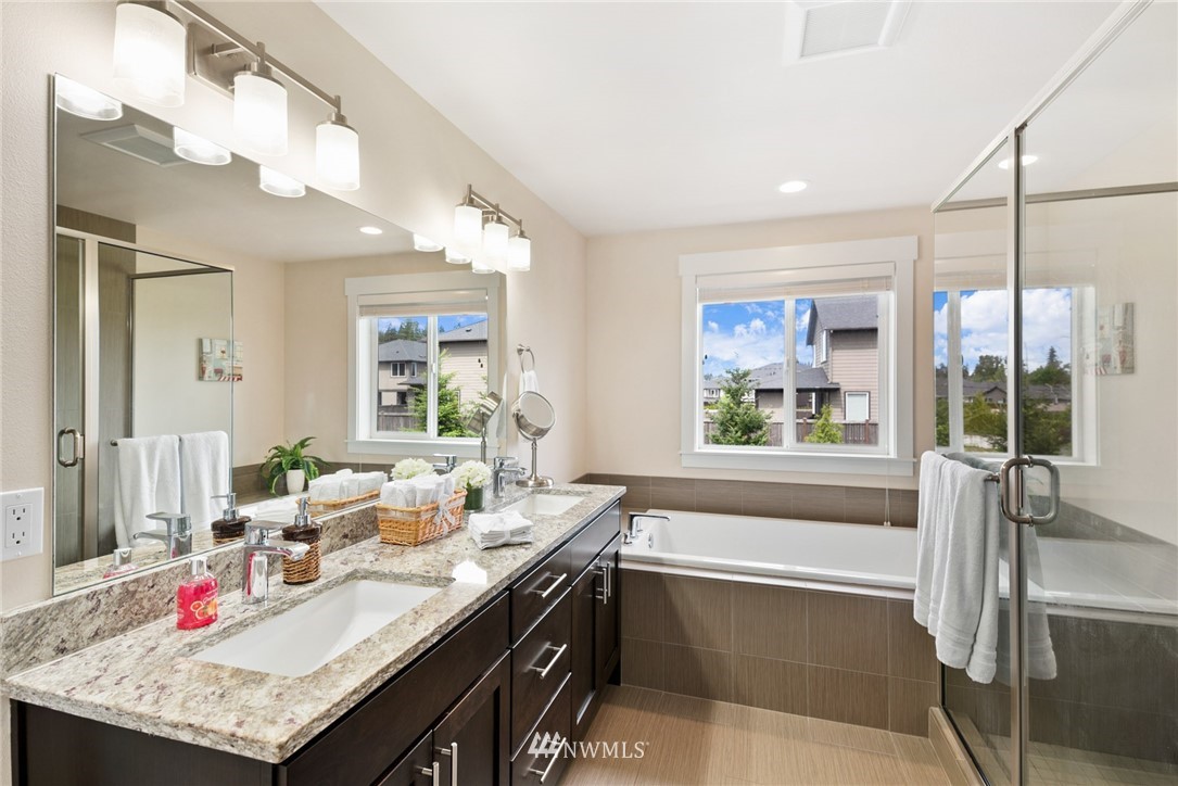 4113 172nd Place Southeast Bothell, WA 98012 - Photo 28 of 32 a bathroom with a tub a sink and a large mirror
