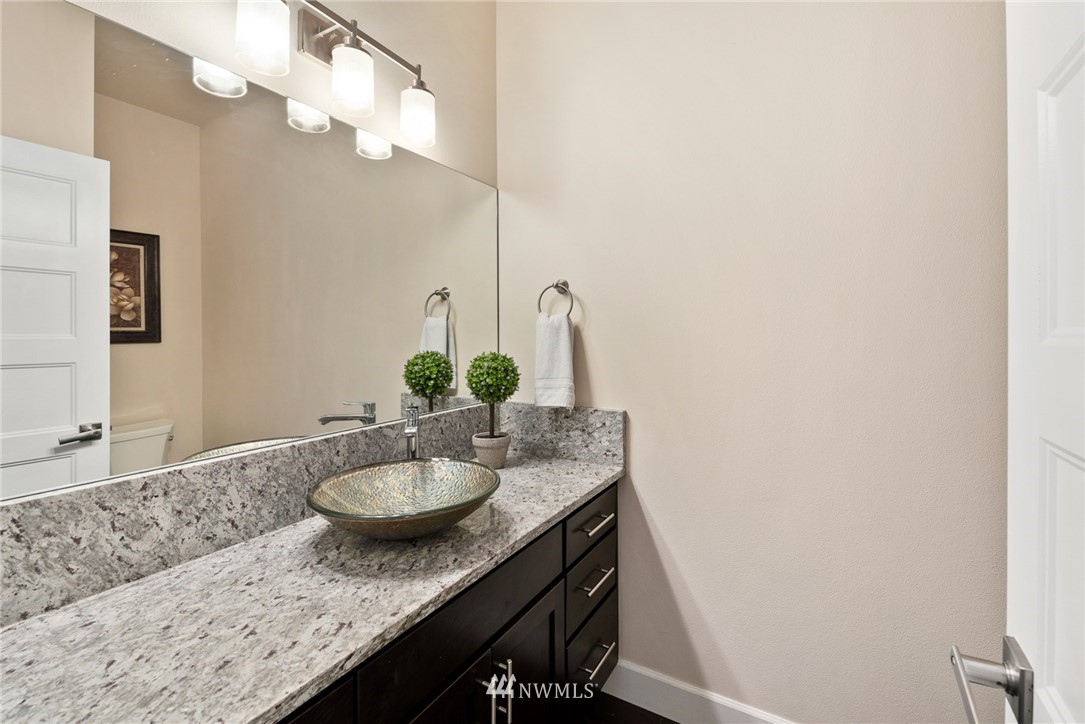 4113 172nd Place Southeast Bothell, WA 98012 - Photo 29 of 32 a bathroom with a granite countertop sink and a mirror