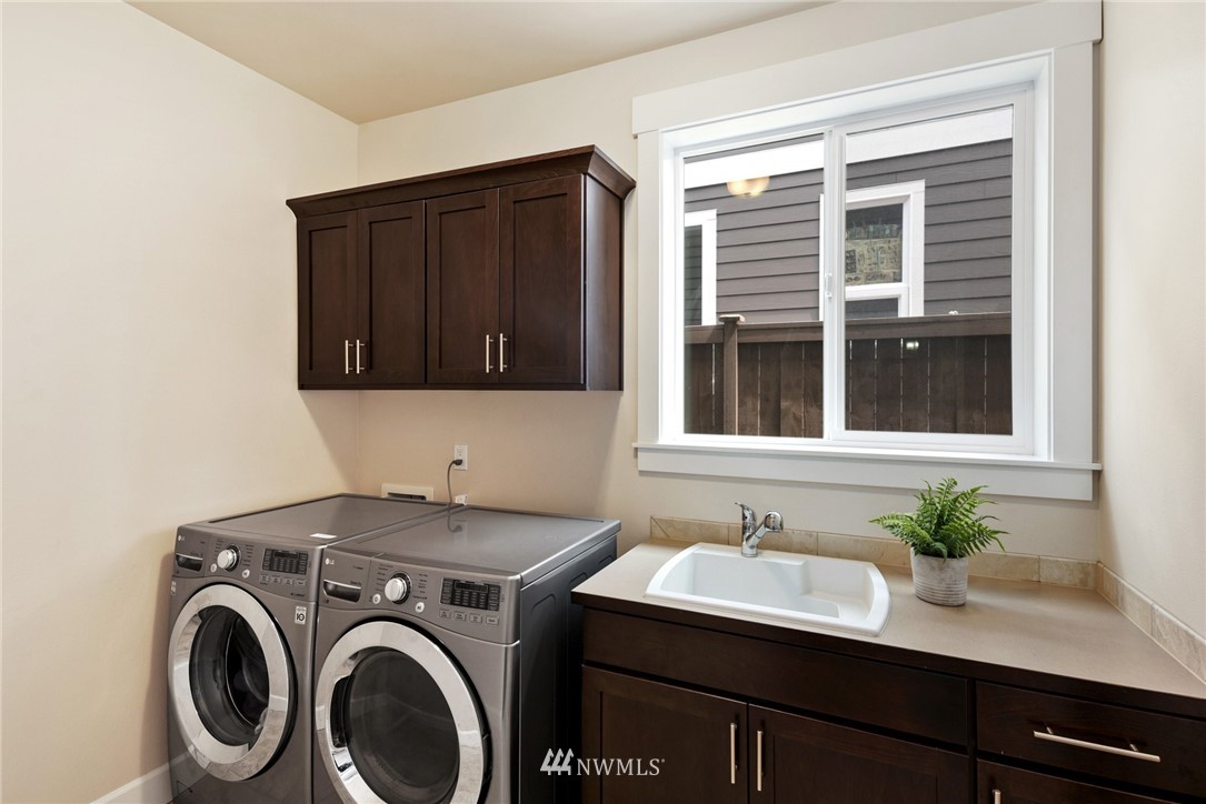 4113 172nd Place Southeast Bothell, WA 98012 - Photo 30 of 32 a bathroom with a sink a washer and dryer