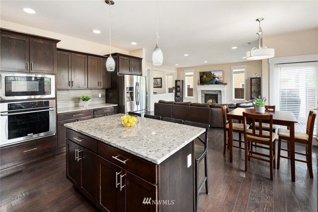 4113 172nd Place Southeast Bothell, WA 98012 - Photo 5 of 32 a kitchen with stainless steel appliances granite countertop a kitchen island a stove and a sink