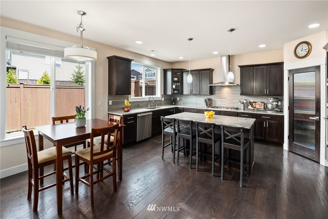 4113 172nd Place Southeast Bothell, WA 98012 - Photo 10 of 32 a large kitchen with a table and chairs