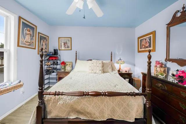 a bed sitting in a bedroom next to a window