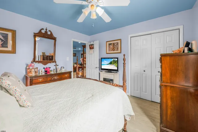 a bedroom with bed and wooden floor