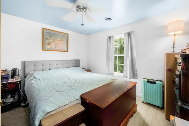 a bedroom with a bed and a lamp on table